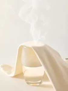 Breathable cream cotton ribbed baby bodysuit showing steam through fabric for ventilation