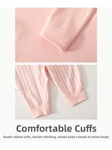 Detailed close-up of soft pink ribbed cuffs and plaid hem showing high-quality stitching