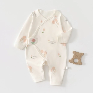 Close-up of soft cotton newborn romper with bear cherry print and side snap buttons