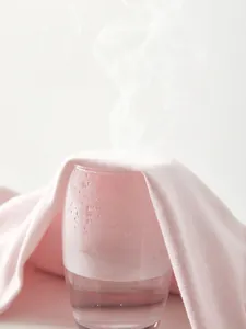 Pink cotton newborn romper featuring breathable and moisture-wicking knitted fabric
