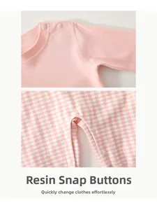 Close-up of baby romper resin snap buttons showing durable texture and pink fabric detail