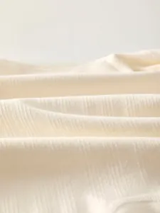 Close-up of cream white combed cotton rib fabric for newborn baby rompers and clothing