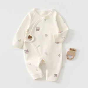 Close-up of cotton newborn romper with cartoon pinecone print and side snap closure