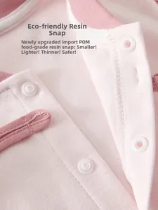 Detail of pink cotton baby romper with safe food-grade resin snap button fasteners