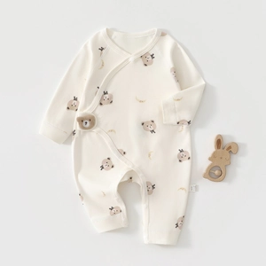 Detail of baby cotton romper with bear prints, side snaps, and 3D bear embroidery