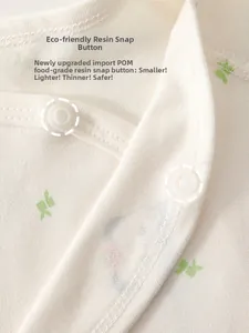 Macro detail of safe food-grade POM resin snaps on soft floral cotton baby clothing