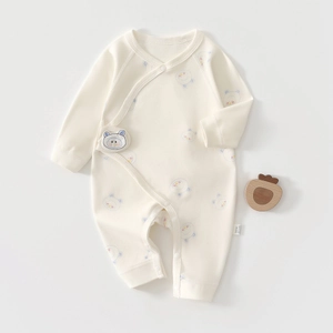 Detail view of cotton baby bodysuit with bear print and snap closure design