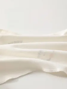 Close-up of soft breathable fine-spun cotton fabric for newborn baby clothes