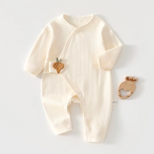 Detailed view of soft ribbed cotton newborn romper with side snaps and carrot patch detail