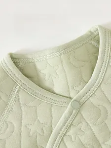 Close-up of baby romper collar with star pattern and safe resin snap buttons