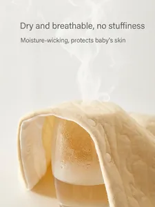 Quilted cotton baby romper in pale yellow with breathable embossed moon and star pattern