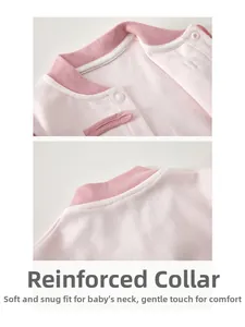 Detail of baby bodysuit collar with pink piping and high-quality white snap buttons