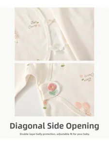 Detail of side-opening cotton newborn baby romper with bear print and adjustable ties
