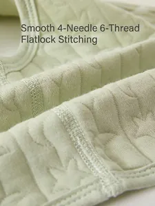 Infant soft cotton vest in pale green with jacquard stars and flatlock seam comfort