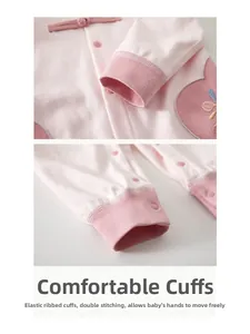 Detail of pink cotton baby romper with elastic ribbed cuffs and double stitching