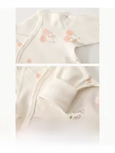 Macro detail of seamless organic cotton baby romper featuring cute bear and cherry print