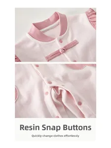 Detail of baby romper featuring resin snap buttons and traditional Chinese knot closure