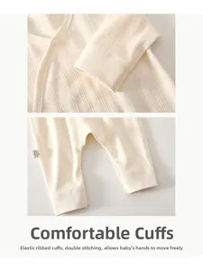 Detail of soft ribbed knit fabric and elastic ribbed cuffs on a white baby romper