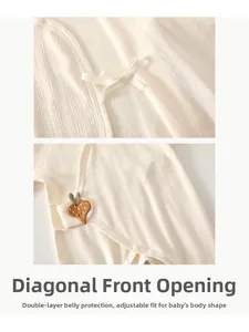 Detail of newborn cotton romper with carrot embroidery and side tie closure design
