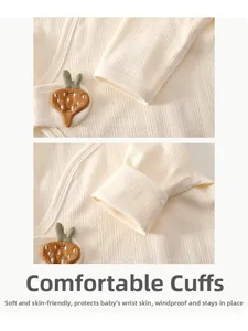 Detail of baby bodysuit sleeve featuring soft ribbed cotton and cute carrot applique