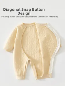 Detail of baby quilted romper with moon star embossing and side snap closure