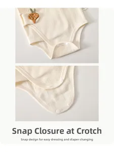 Close-up of three bottom resin snaps on ribbed cotton baby bodysuit for easy diaper change