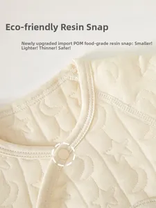 Detail of infant bodysuit neckline with secure food-grade resin snap buttons and moon pattern