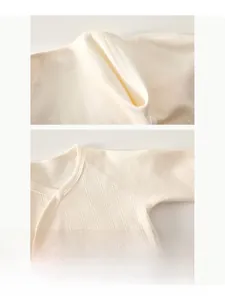 Détails de couture plate sur ce haut en coton pour nouveau-né avec texture côtelée