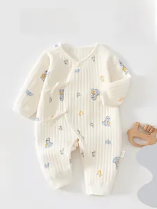 Detail of baby quilted romper featuring waffle texture and cute cartoon dinosaur print