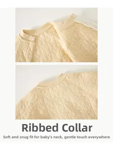 Detail view of baby bodysuit neckline with quilted star embossing and snaps