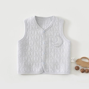 Detail of baby quilted vest with star and moon patterns and Class A safety cotton label