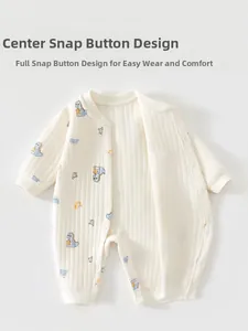 Detail of baby quilted romper featuring dinosaur patterns and snap-button closure