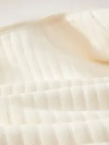 Close-up of soft ribbed cotton fabric with breathable texture for newborn baby onesie