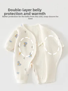 Detail view of cotton baby romper with blue dinosaur print and double-layer belly protection