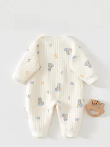 Detailed back view of a quilted cotton baby romper with cute blue dinosaur patterns