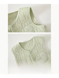 Close-up of baby quilted vest with moon embroidery and star texture detail