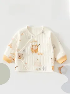Close-up of quilted newborn baby wrap top with bear print and snap buttons