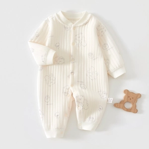 Close-up of baby romper cotton fabric texture with bear print and snap buttons