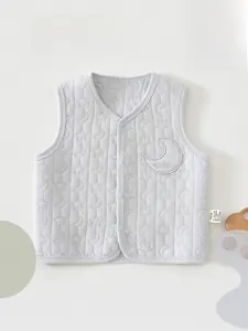 Detailed view of quilted baby vest with star and moon patterns and snap buttons