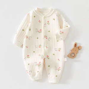 Detail of baby quilted cotton romper featuring pink tulips and cute rabbit patterns