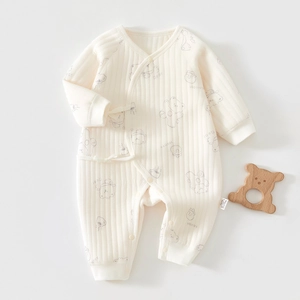 Detail of baby quilted cotton romper with soft ribbed texture and cute bear prints