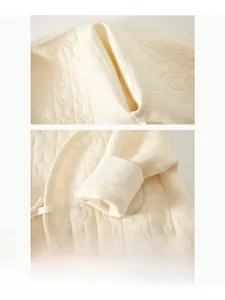 Detailed macro view of seamless stitching and quilted pattern on warm cotton baby romper
