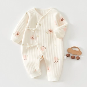 Detailed view of newborn floral romper featuring vertical rib texture and soft side ties