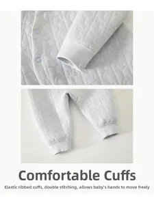 Détail de la barboteuse matelassée pour bébé avec motifs lune et poignets côtelés