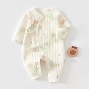 Detailed view of cream newborn cotton romper with rabbit print and side tie closure