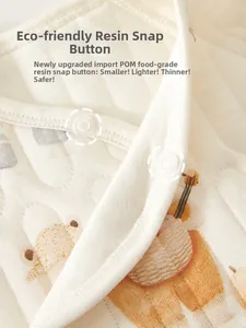 Detail of eco-friendly resin snap buttons on quilted newborn thermal cotton top