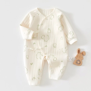 Detail of baby cotton quilted romper showing ribbed texture and green rabbit pattern