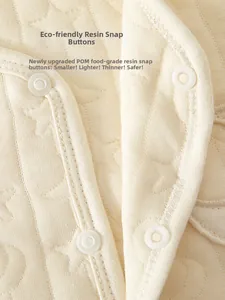Macro shot of safe food-grade resin snap buttons on quilted cotton baby vest