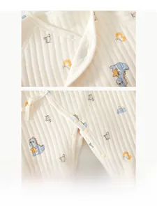 Detailed macro view of resin snap buttons on soft quilted cotton baby jumpsuit fabric