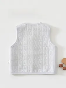 Detail view of baby quilted vest with star and moon patterns on the back side